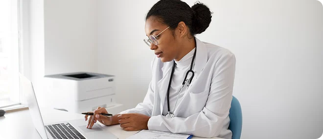 Doctor reviewing patient information on a laptop