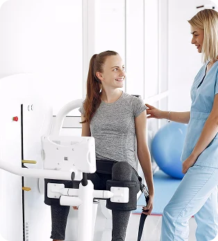 Patient using rehabilitation equipment with assistance
