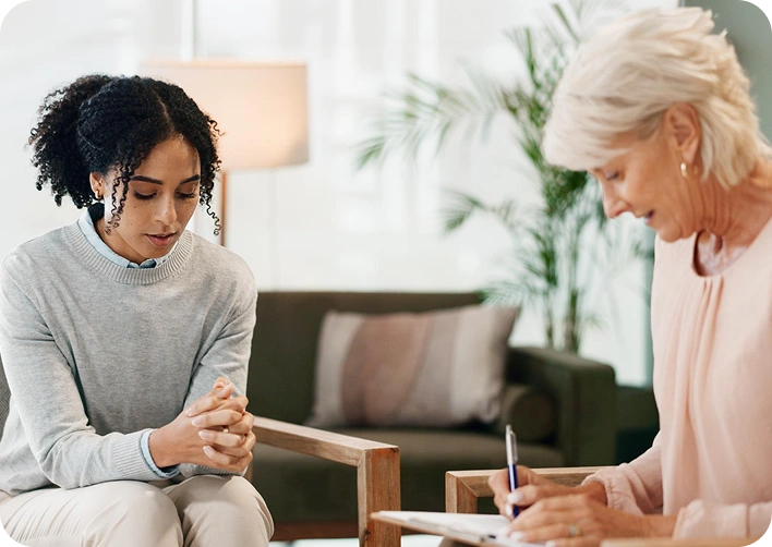 Therapist taking notes during a counseling session