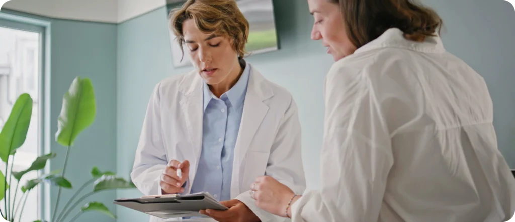 Two medical professionals reviewing patient charts