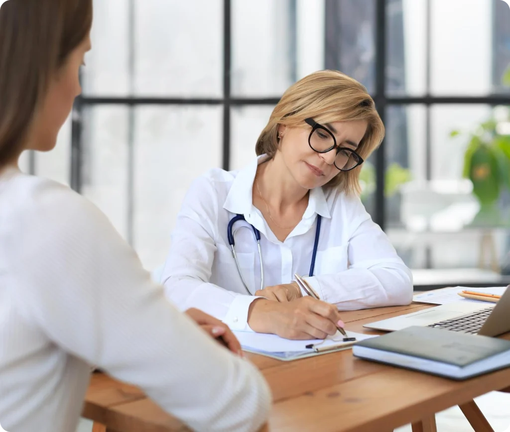 Doctor writing medical notes for a patient