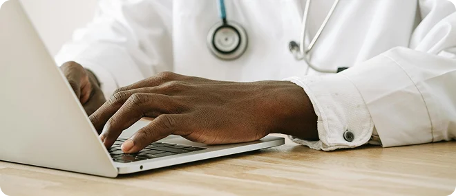 Doctor using a laptop for online patient care