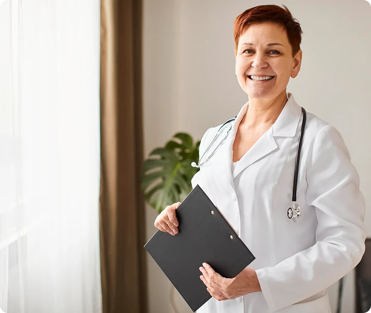 Smiling female doctor holding a clipboard