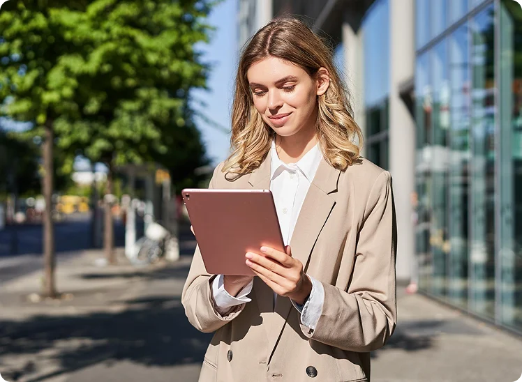 Woman using a tablet outdoors
