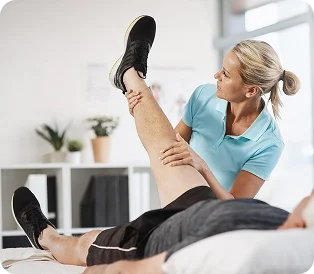 Physical therapist examining a patient’s leg