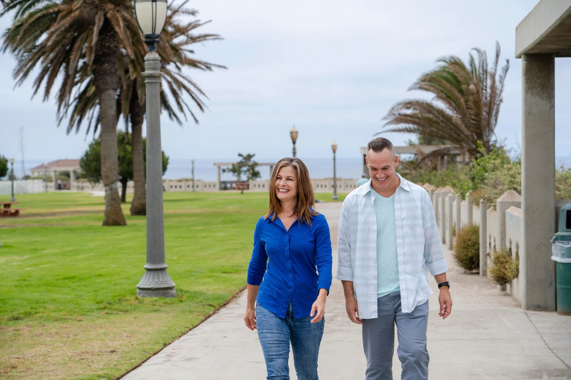 Couple walking through a coastal park near Surfside