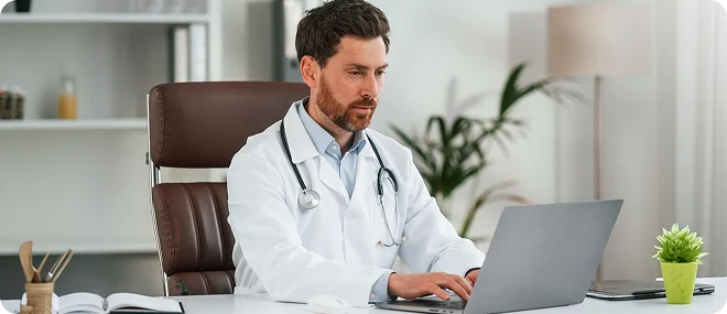 Primary care doctor reviewing patient information online