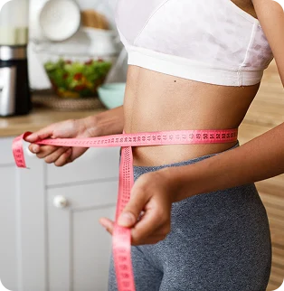 Woman measuring her waist during a weight loss program
